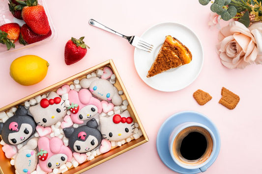 A styled dessert table spread with character macarons and cake